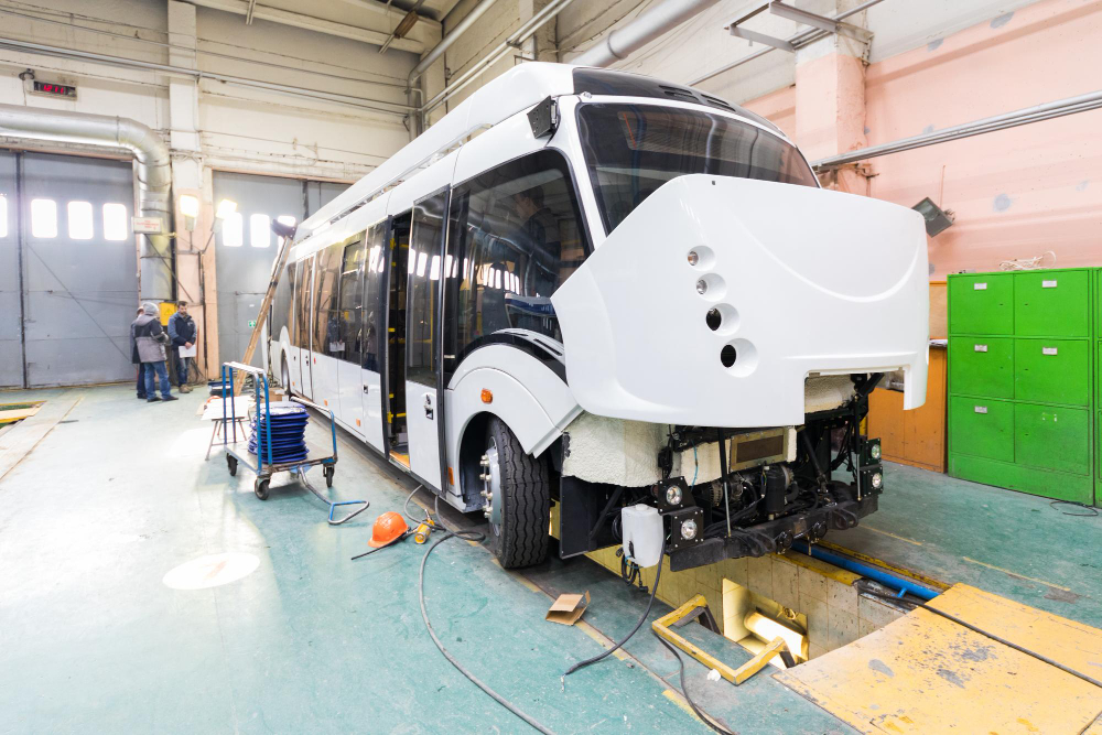 one-working-day-modern-automatic-bus-manufacturing-with-unfinished-cars-workers-protective-uniform-automobile-production.jpg